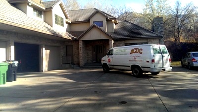 ACDC van in a snowy residential driveway