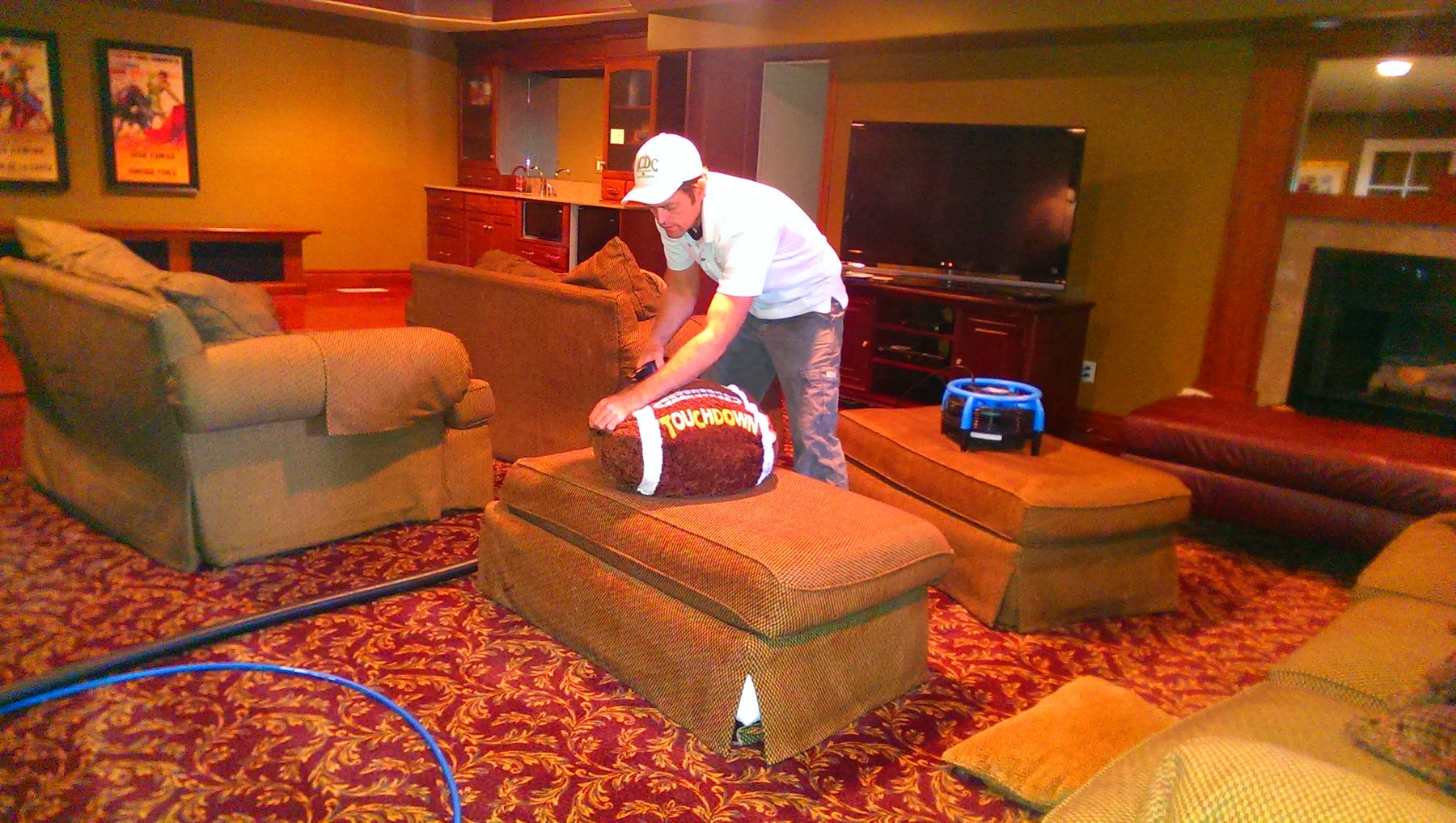 Technician resetting furniture after carpet cleaning