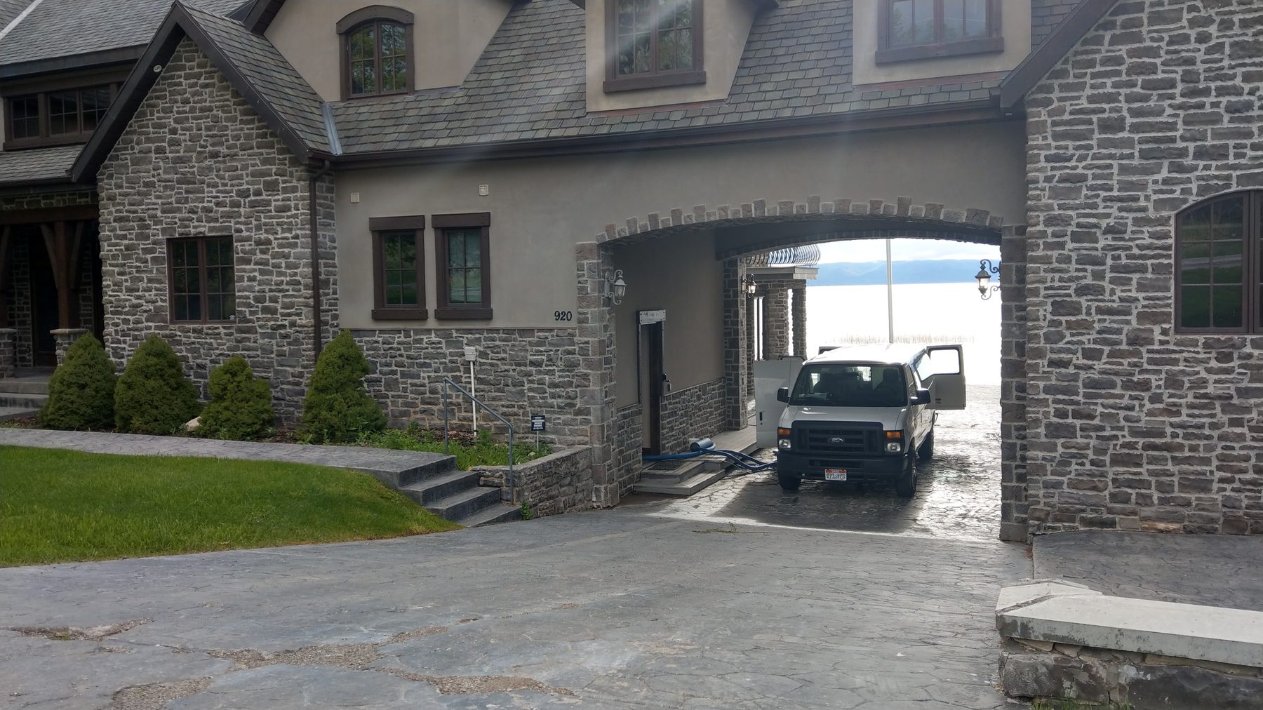 ACDC van and truck-mount hoses at a stone home