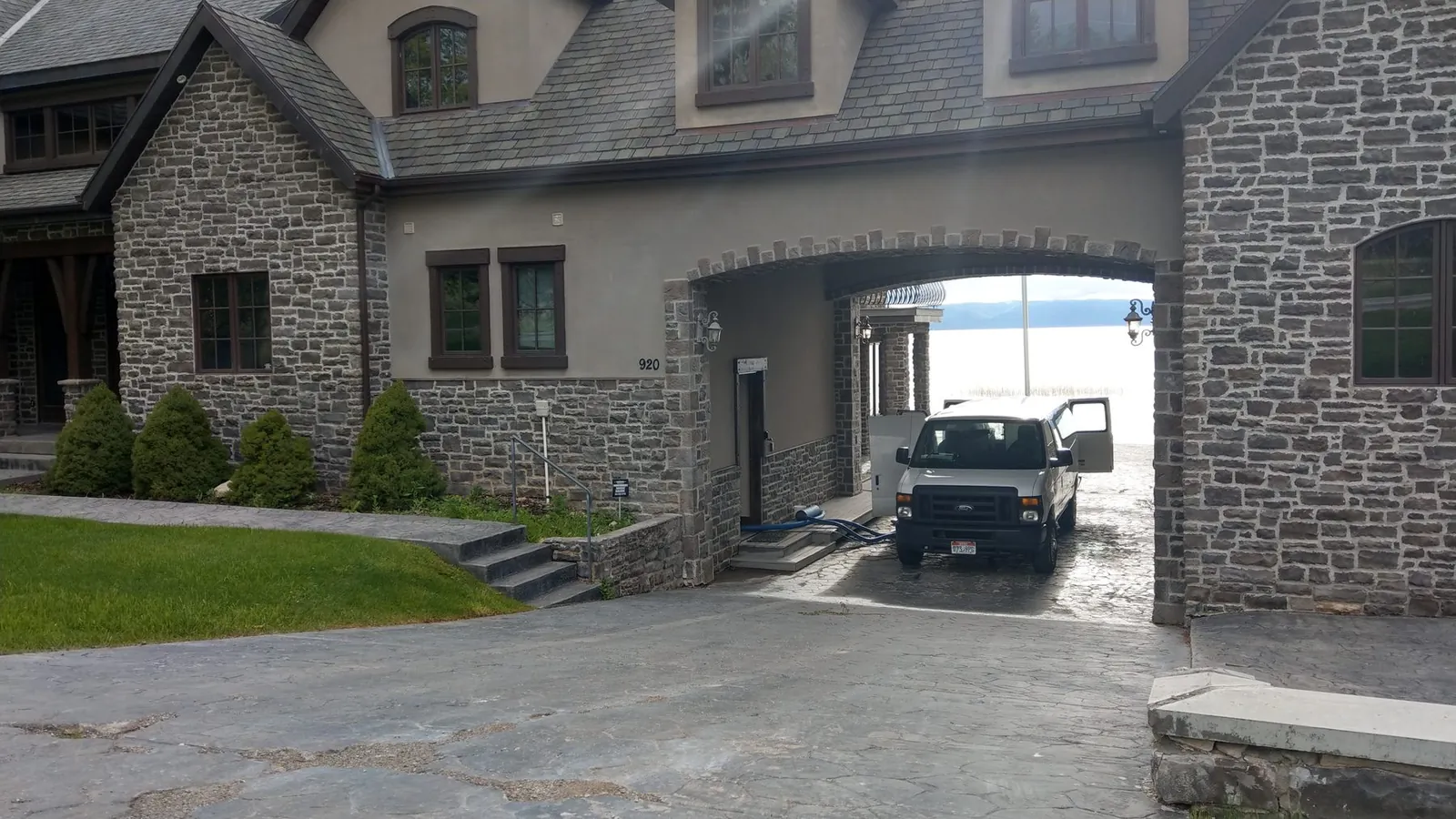 ACDC van and truck-mount hoses at a stone home
